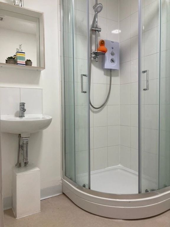 Property photo 3 of 6 Bright, Modern Bathroom With A Corner Shower Enclo...