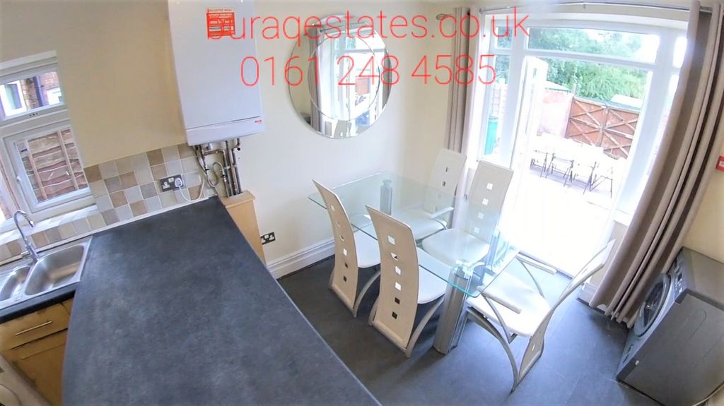 Property photo 3 of 15 Bright And Modern Kitchen Featuring A Sleek Counte...