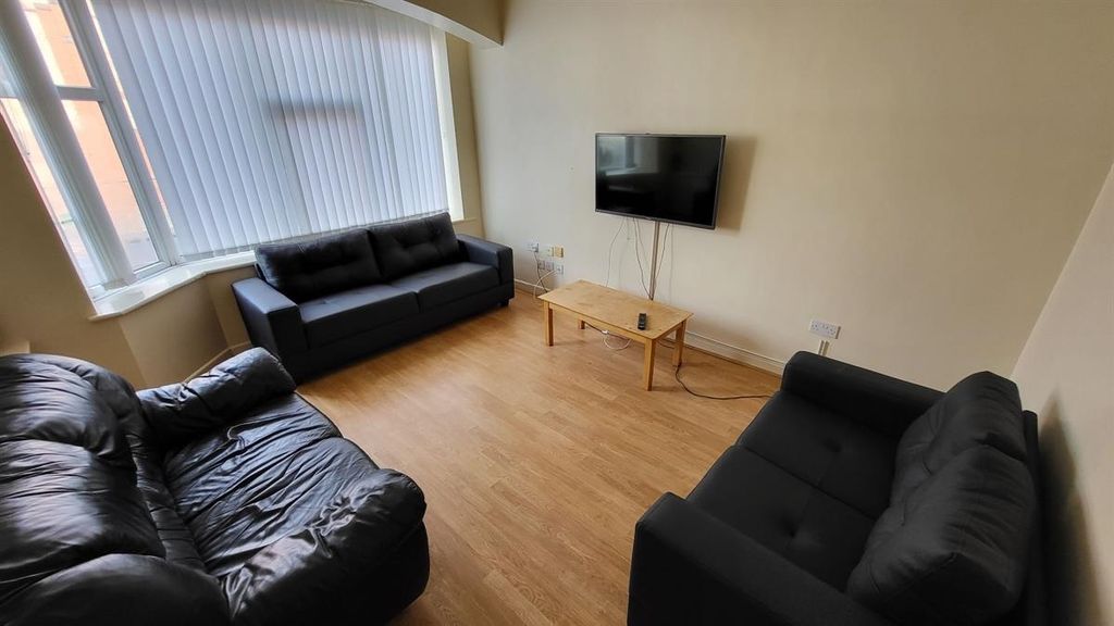Property photo 2 of 15 Bright And Inviting Living Room Featuring A Large ...
