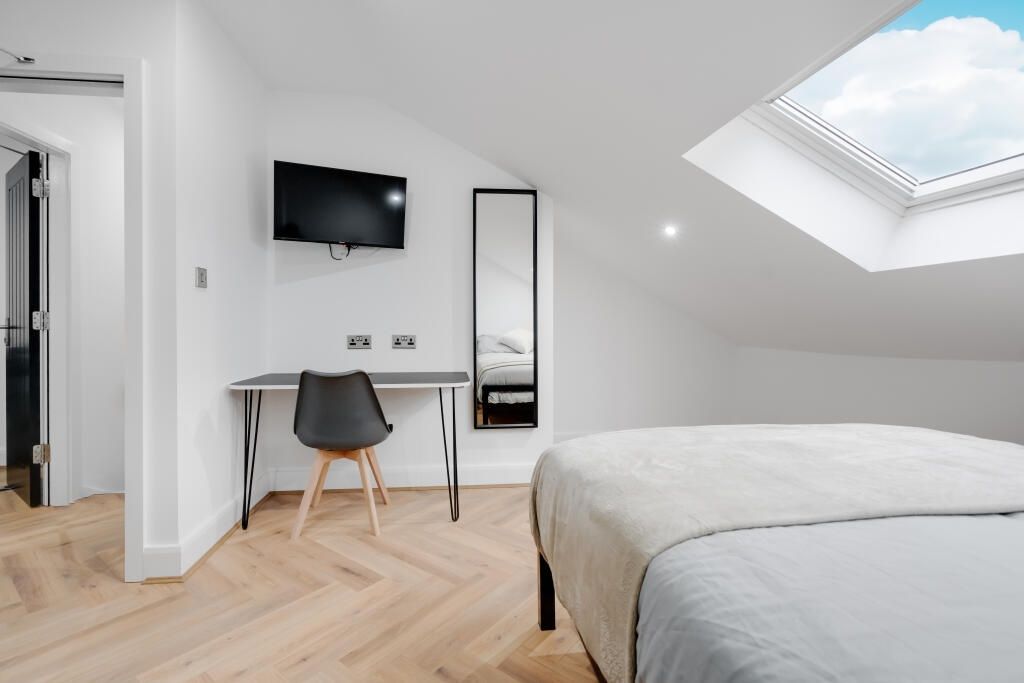 Property photo 1 of 14 A Bright And Modern Bedroom Featuring Ample Natura...