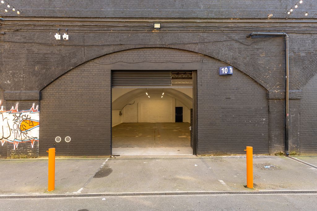 Property photo 3 of 4 The Front Of An Arch With An Open Electric Roller Shutter Entrance Big Enough For Vehicle Access, And Separate Pedestrian Door.