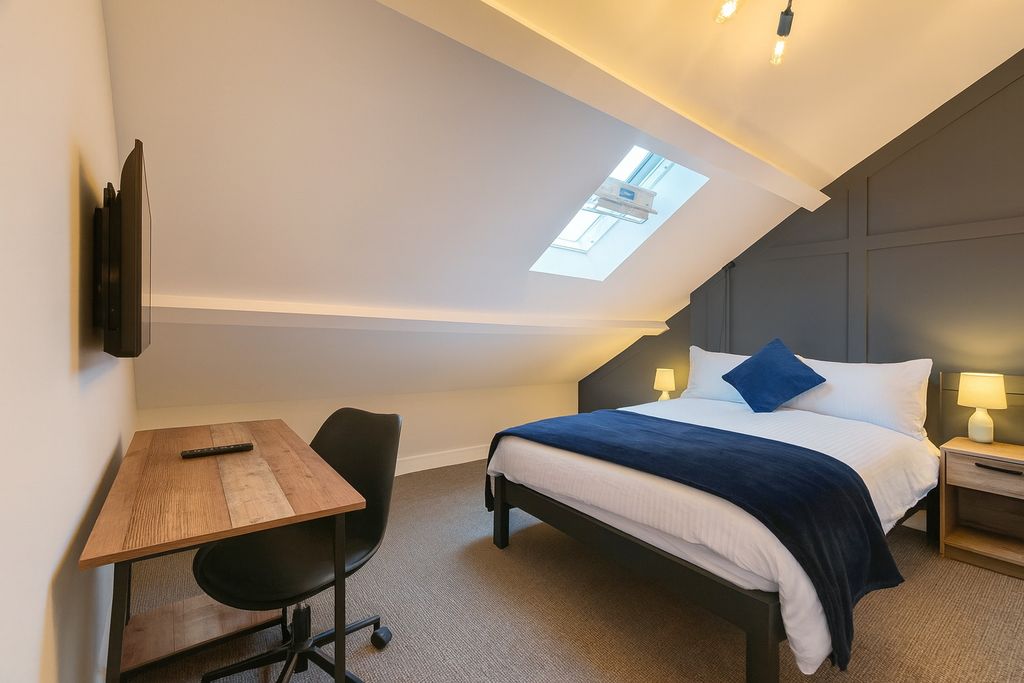 Property photo 2 of 6 A Modern, Well-Lit Master Bedroom Featuring A Comf...
