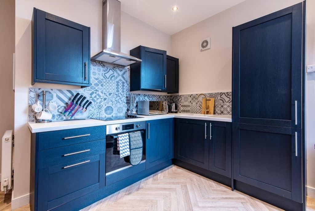 Property photo 2 of 7 This Stylish Kitchen Features Modern Cabinetry And...