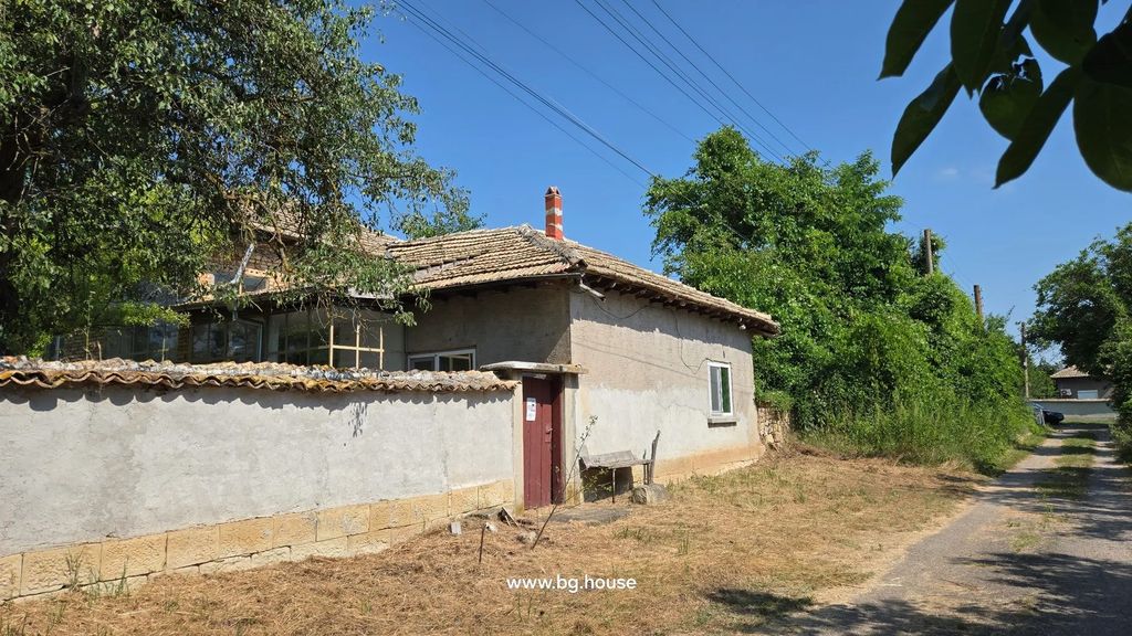 Property photo 1 of 100 View Of The House Exterior Showing The Tiled Roof, Chimney, And Surrounding Wall With A Wooden Door.