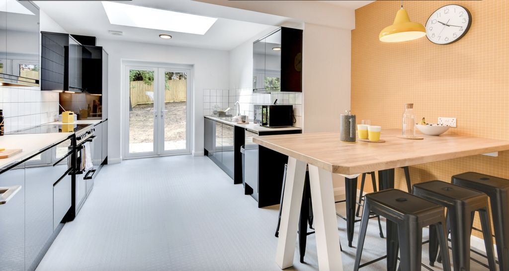 Property photo 1 of 6 This Modern Kitchen Features Sleek Black Cabinetry...