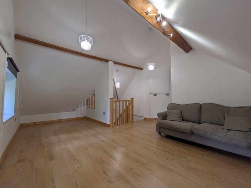 Property photo 2 of 12 Spacious And Contemporary Living Room Featuring Wo...