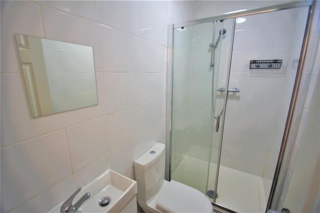 Property photo 3 of 11 A Modern Bathroom Featuring A Sleek Shower Stall, ...