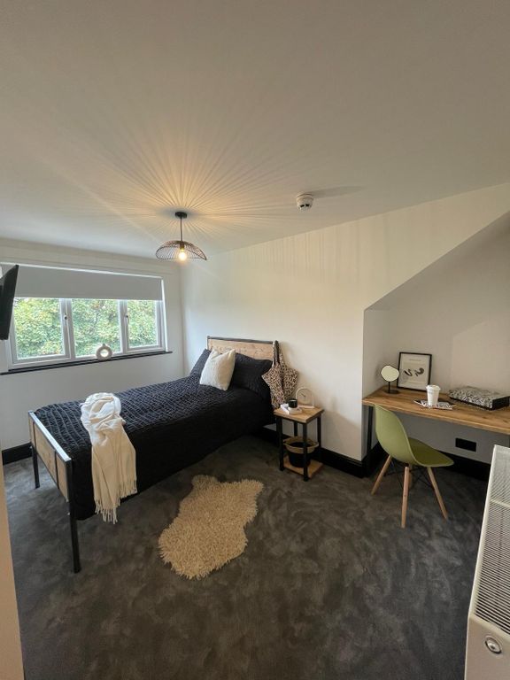 Property photo 2 of 4 A Spacious And Well-Lit Bedroom Featuring A Large ...