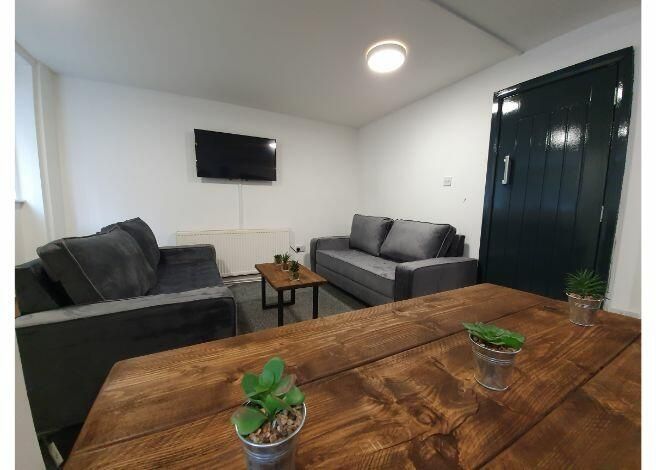 Property photo 2 of 5 A Modern, Well-Lit Living Room Featuring Contempor...