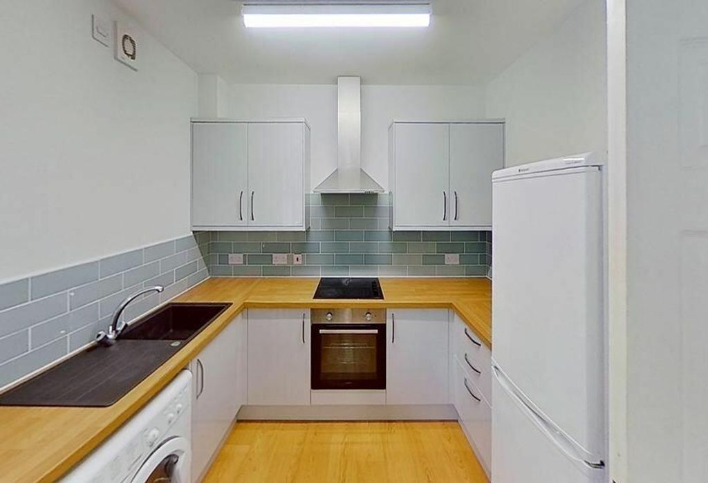 Property photo 3 of 4 This Modern Kitchen Features Sleek Cabinetry, Ampl...