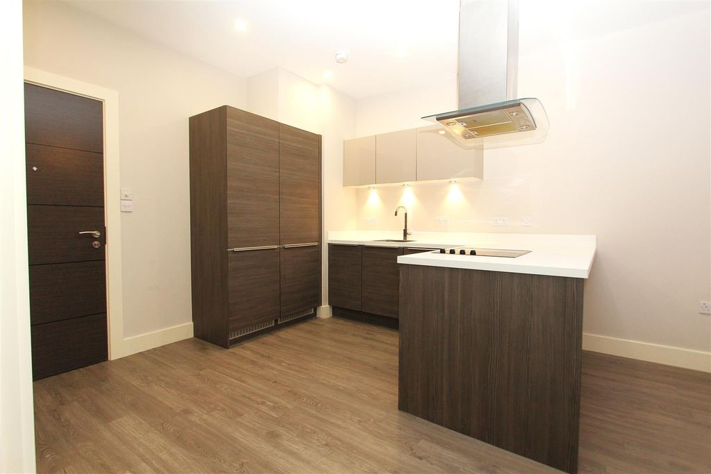 Property photo 2 of 8 Modern Kitchen With Sleek Dark Wood Cabinetry...