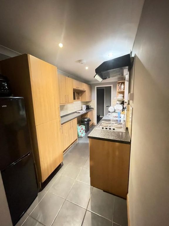 Property photo 3 of 4 A Modern Kitchen Featuring Wooden Cabinetry And A ...