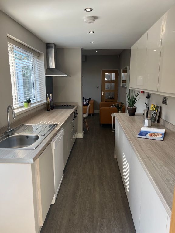 Property photo 2 of 6 Bright, Modern Galley Kitchen With Light Wood-Effe...