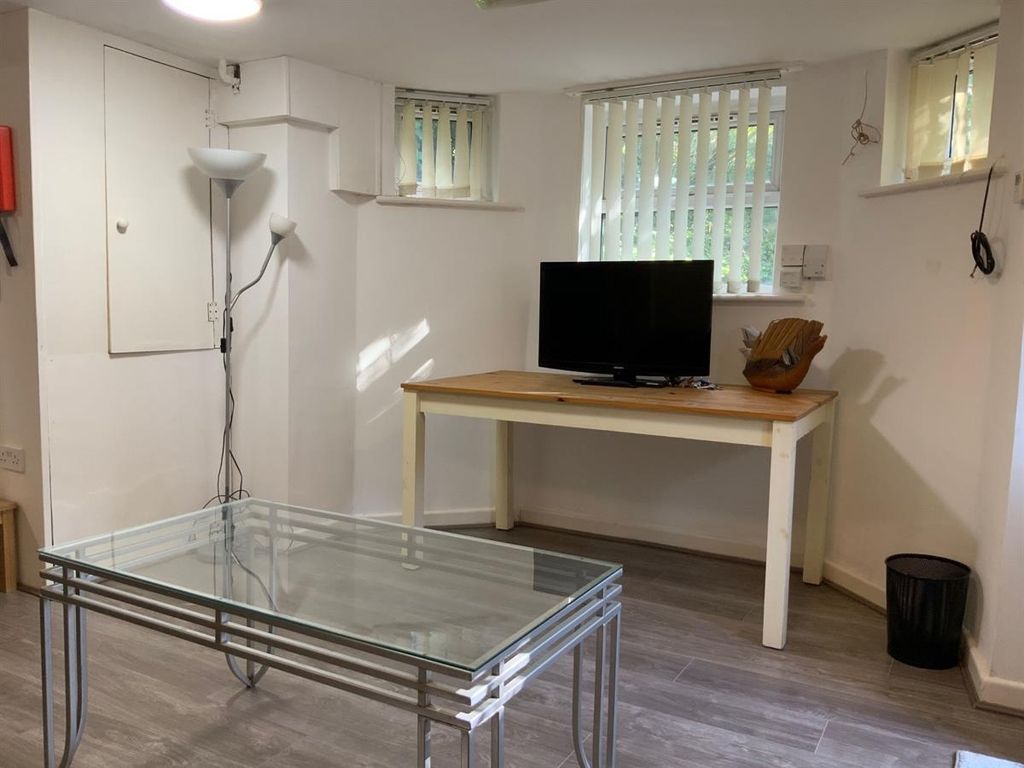 Property photo 3 of 12 Bright, Simply Furnished Living Area With A TV On ...