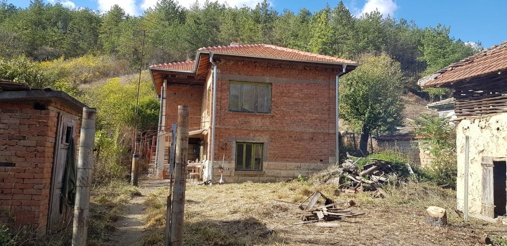 Property photo 1 of 73 View Of A Two-Storey Brick House With A Tiled Roof Surrounded By Natural Vegetation And Hills