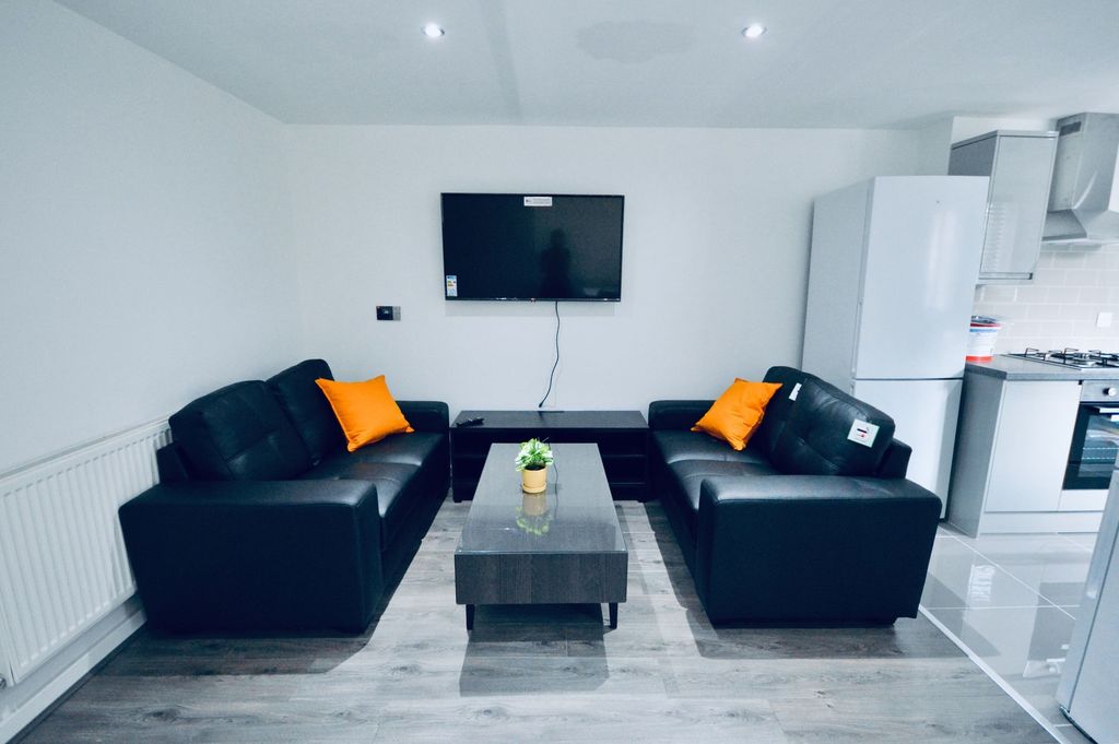 Property photo 1 of 4 Modern And Inviting Living Room Featuring Two Blac...