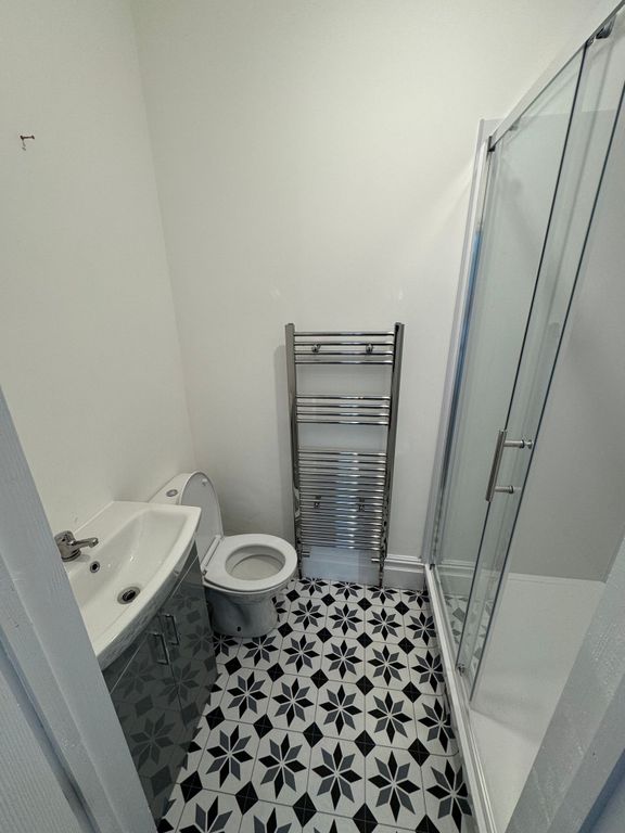 Property photo 3 of 9 A Modern Bathroom Featuring A Patterned Black And ...