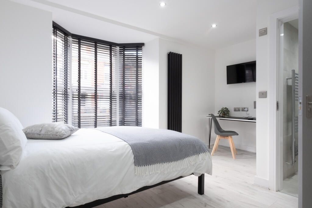 Property photo 1 of 15 Bright And Modern Master Bedroom Featuring A Comfo...
