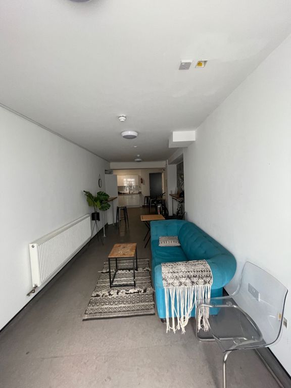 Property photo 1 of 6 This Stylish Living Room Features A Cozy Turquoise...