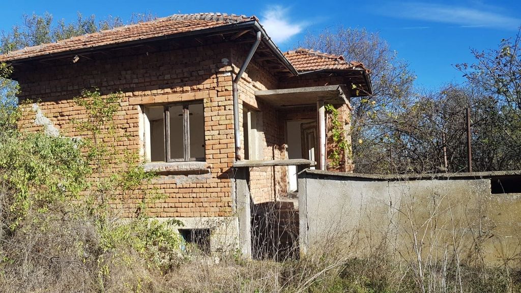 Property photo 1 of 34 View Of The Brick House Exterior Showing Tiled Roof And Small Porch Surrounded By Overgrown Vegetation