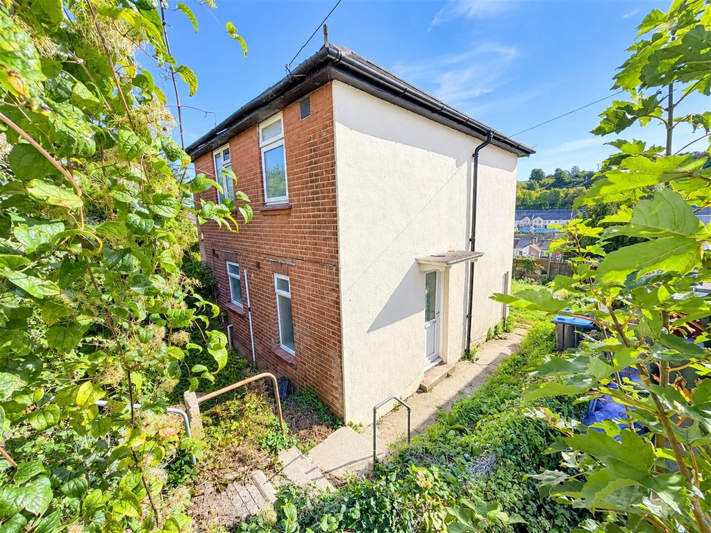 Property photo 1 of 10 Sunlit House Framed By Lush Greenery.Png