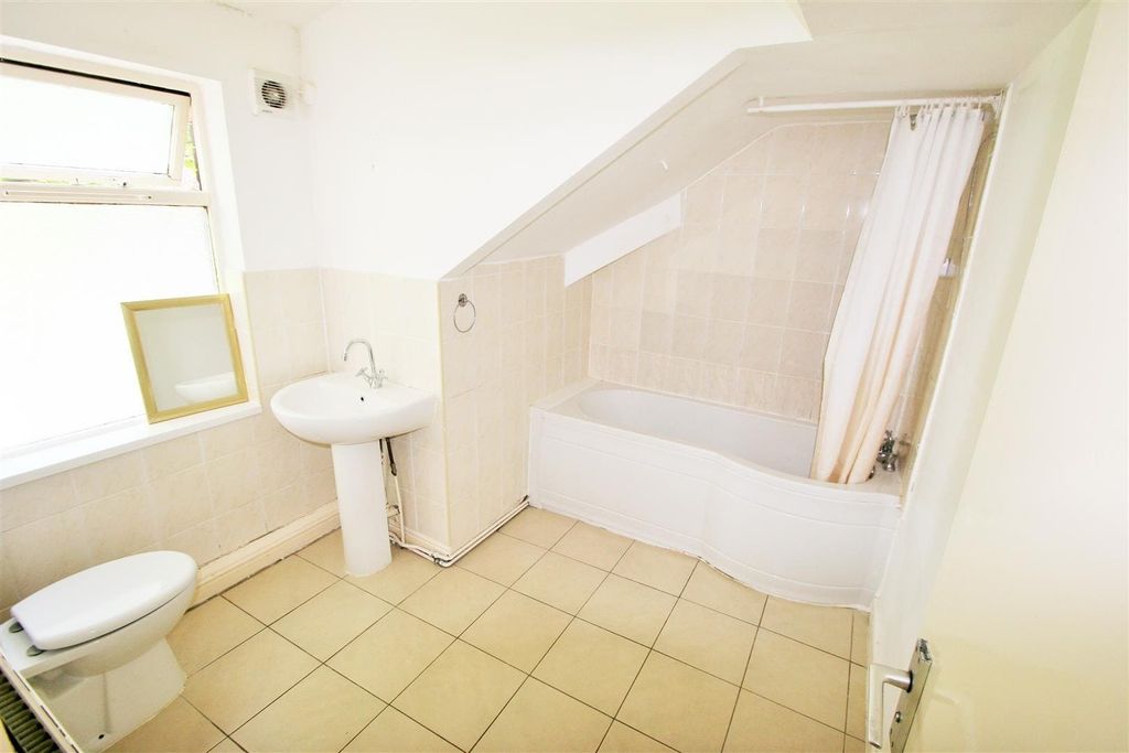 Property photo 3 of 4 Bright And Clean Bathroom Featuring A Bathtub, A S...