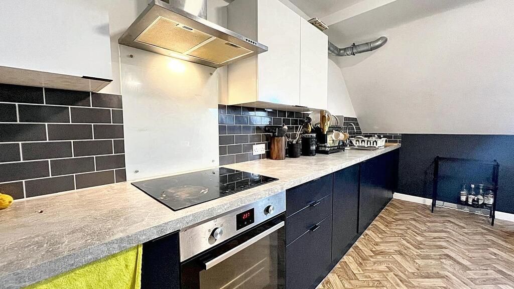 Property photo 2 of 7 Modern Galley-Style Kitchen With Sleek Dark Lower ...