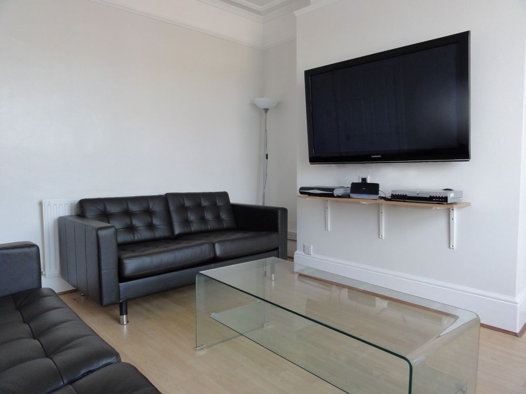 Property photo 1 of 18 Modern Living Room Featuring A Sleek Black Leather...