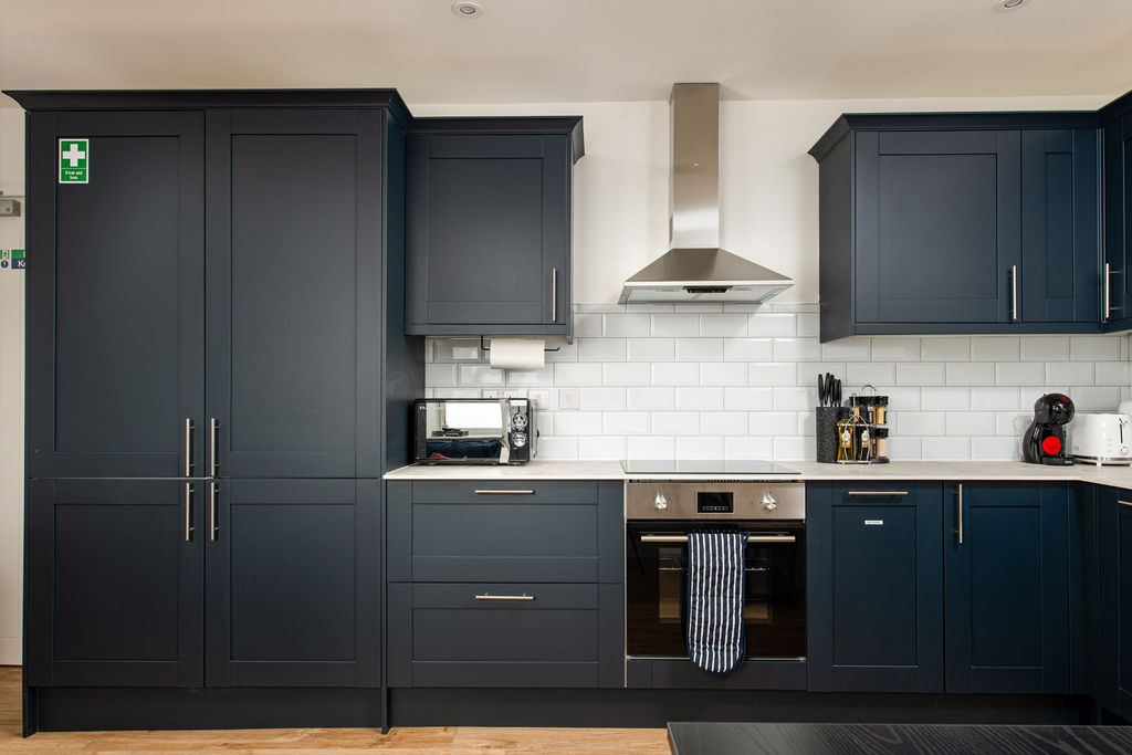 Property photo 2 of 8 This Modern Kitchen Features Sleek Navy Cabinets A...