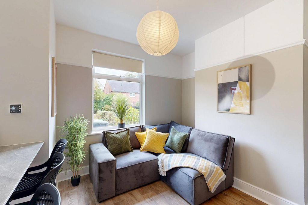 Property photo 3 of 10 A Bright And Welcoming Living Room Featuring A Lar...