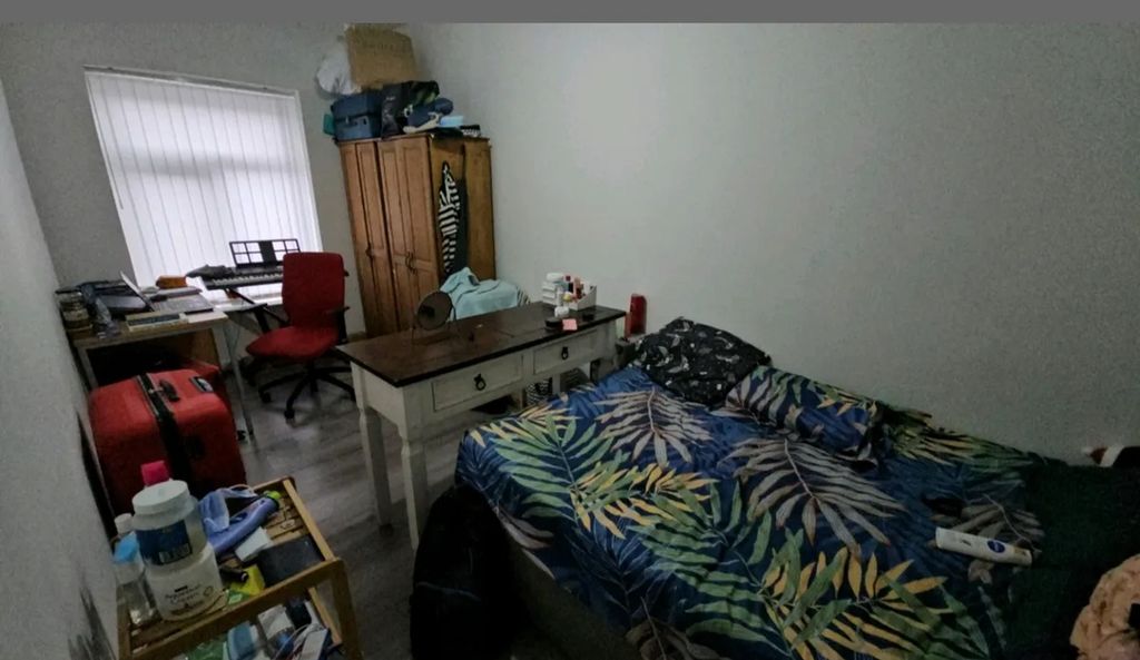 Property photo 3 of 8 A Cozy Double Bedroom Featuring A Vibrant Tropical...