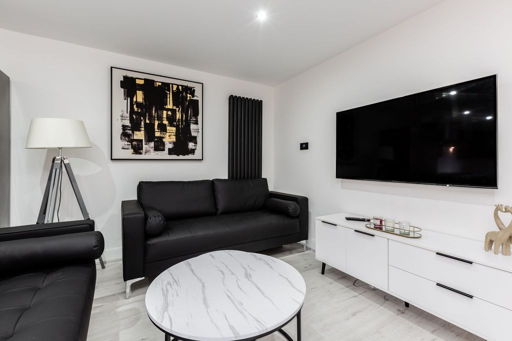 Property photo 1 of 6 Modern And Stylish Living Room Featuring A Sleek B...