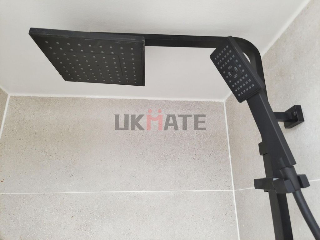Property photo 1 of 5 A Modern Bathroom Featuring A Sleek Overhead Showe...