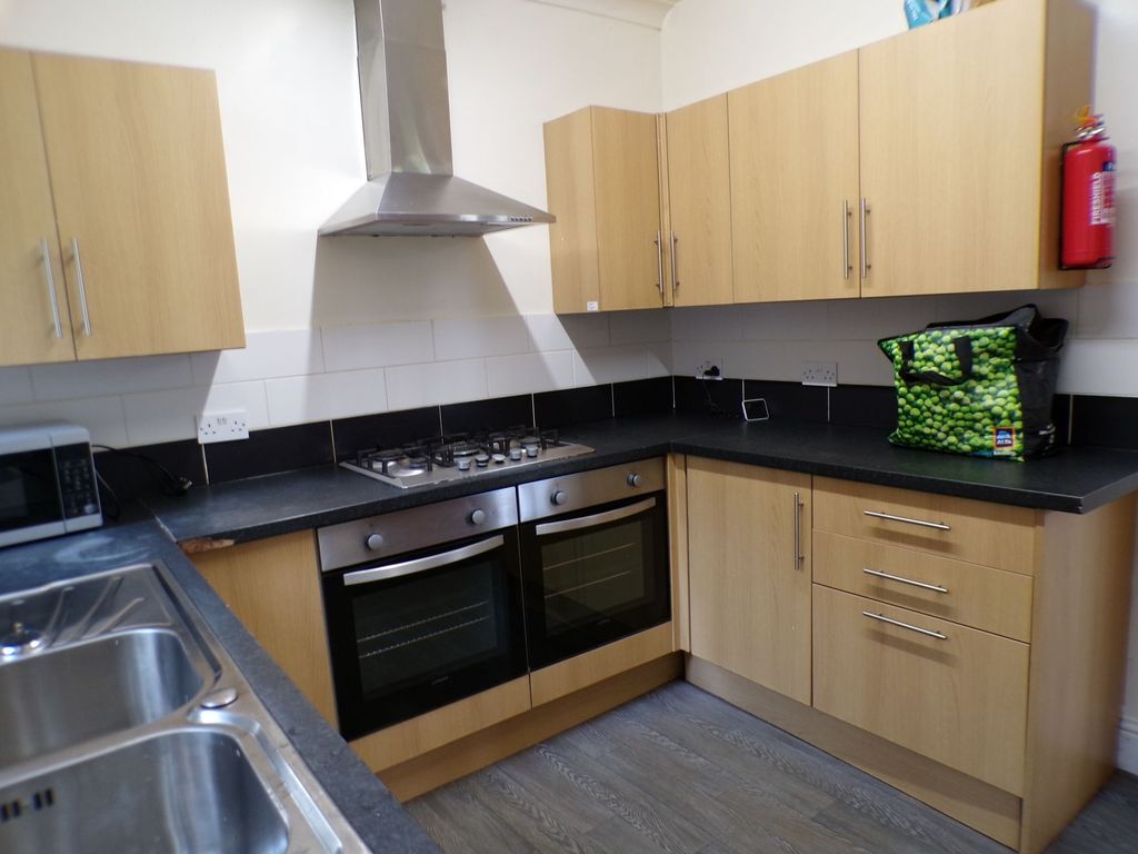 Property photo 3 of 9 Modern Kitchen Featuring Wooden Cabinets, A Stainl...