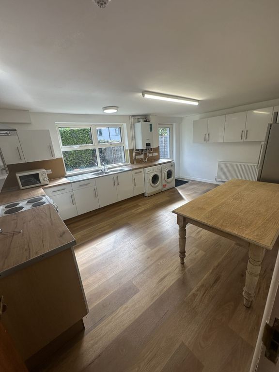 Property photo 1 of 5 A Brightly Lit, Modern Kitchen With White Cabinets...