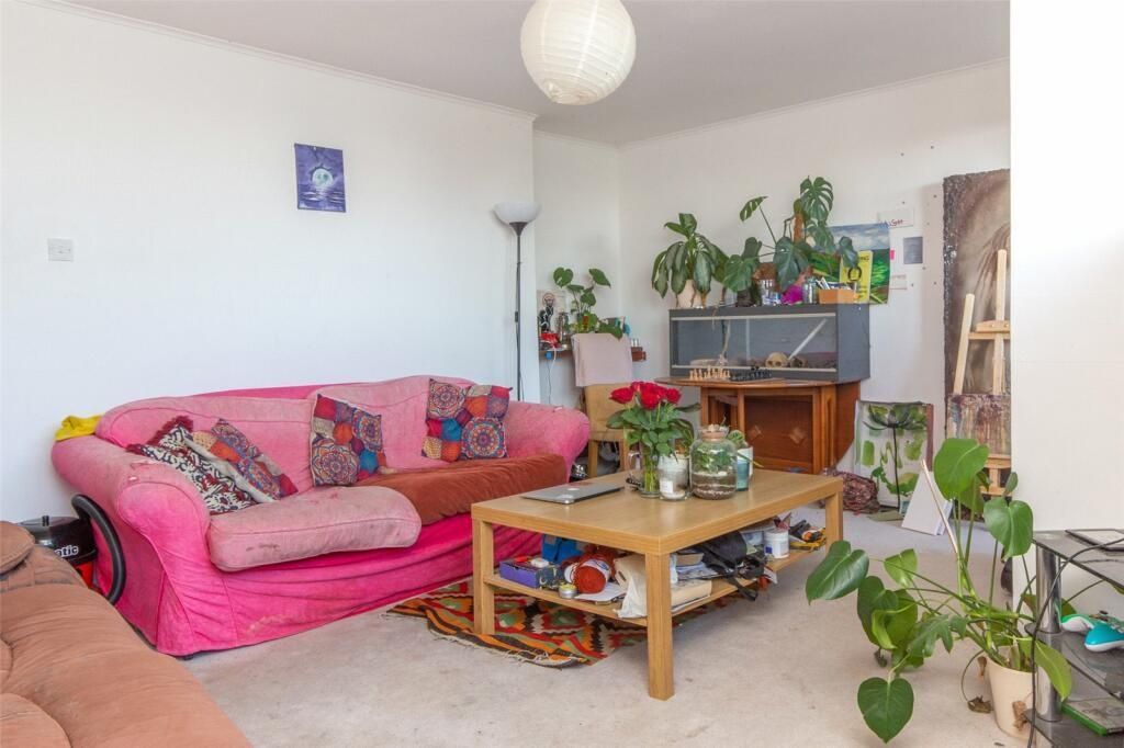 Property photo 2 of 7 A Bright And Inviting Living Room Featuring A Comf...