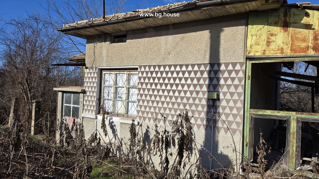Property photo 2 of 29 Close-Up Side View Of The House Showing Patterned Exterior Walls, Windows With Metal Grilles, And A Rusty Metal Frame Structure.