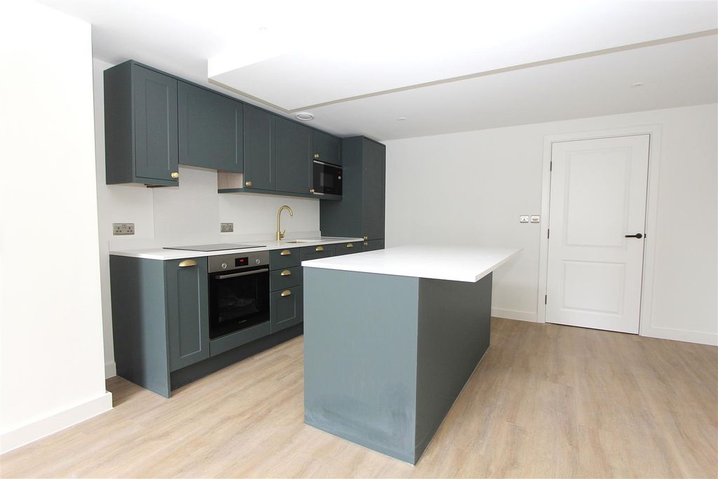 Property photo 1 of 17 Modern Kitchen With Sleek Island And Gold Accents...
