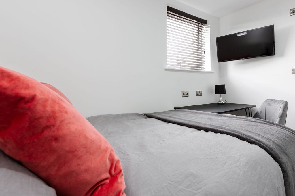 Property photo 2 of 4 A Spacious And Well-Lit Bedroom Featuring A Double...