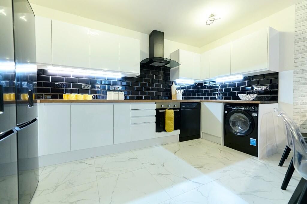 Property photo 3 of 14 Bright And Modern Kitchen With Sleek White Cabinet...