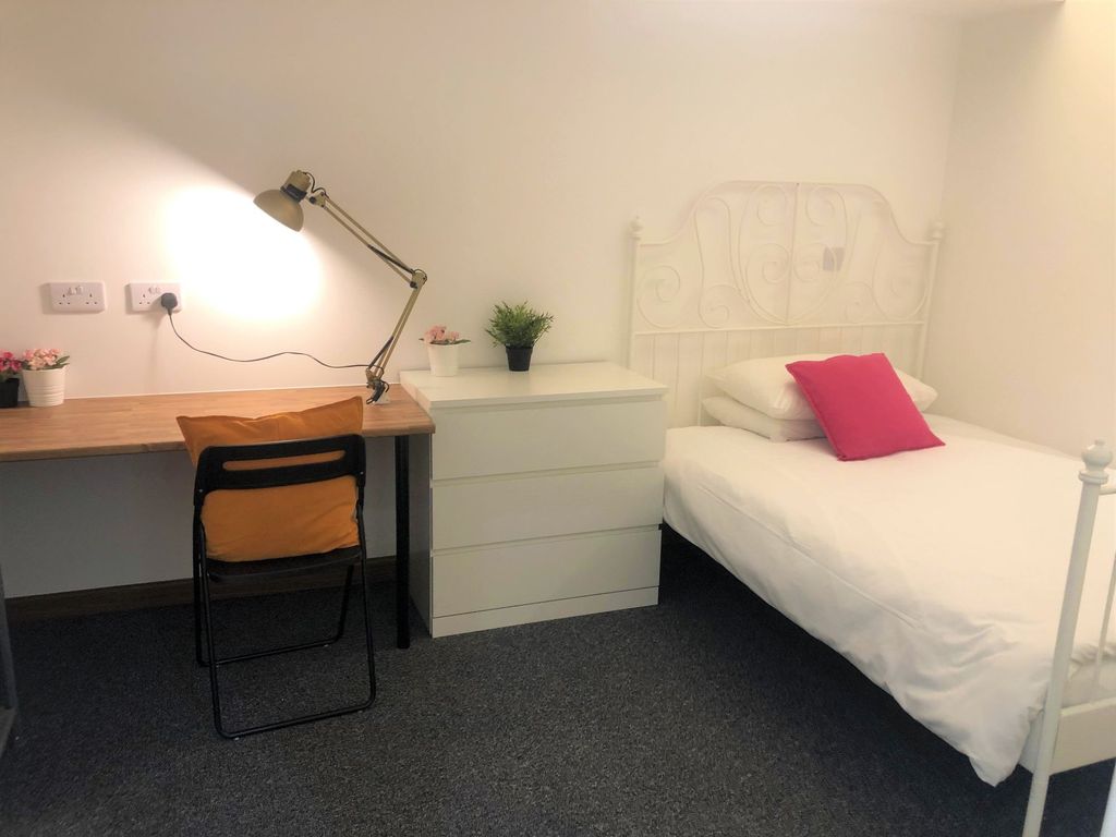 Property photo 2 of 35 A Cozy Single Bedroom Featuring A Neat White Metal...