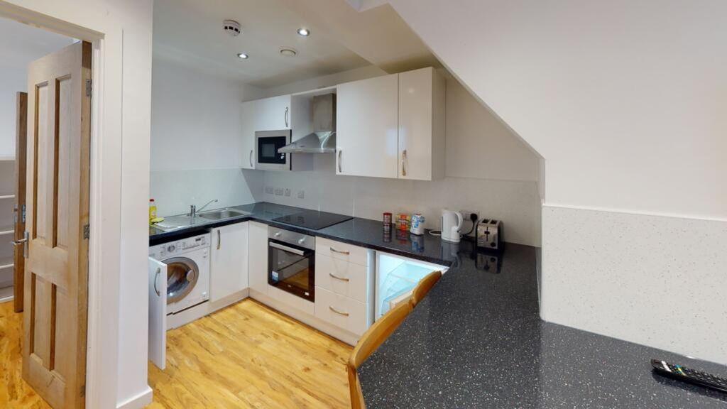 Property photo 1 of 5 A Modern Kitchenette Featuring Sleek Appliances An...