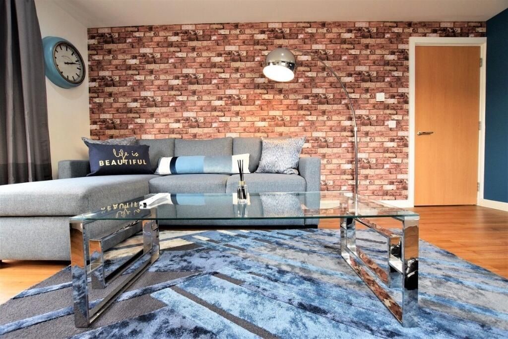 Property photo 3 of 7 A Stylish Living Room Featuring A Modern Exposed B...