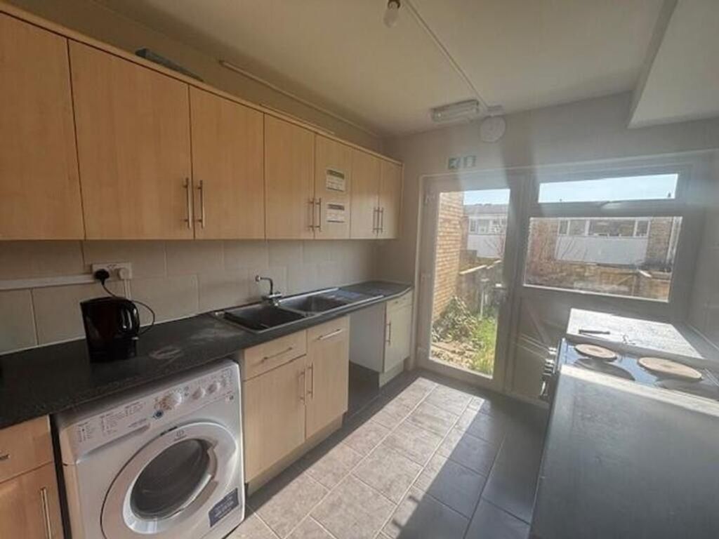 Property photo 1 of 8 Spacious Kitchen Featuring Modern Cabinetry, Ample...