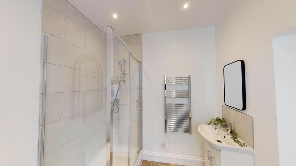 Property photo 2 of 12 A Spacious And Modern Bathroom Featuring A Sleek d...