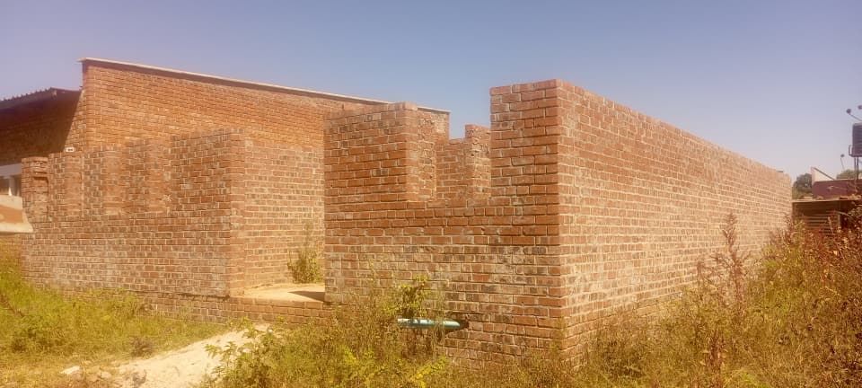 Property photo 3 of 5 Partial Brick Structure With Tall Exterior Walls In A Dry, Overgrown Lot Under A Clear Blue Sky