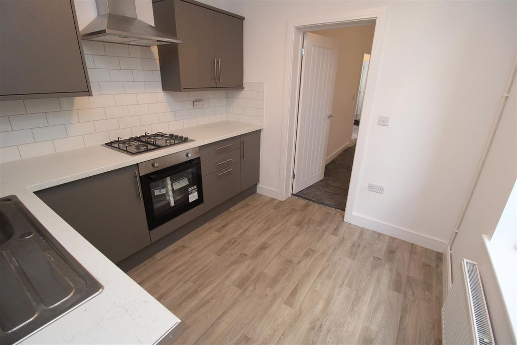 Property photo 3 of 24 Modern Kitchen With Sleek Grey Cabinetry...