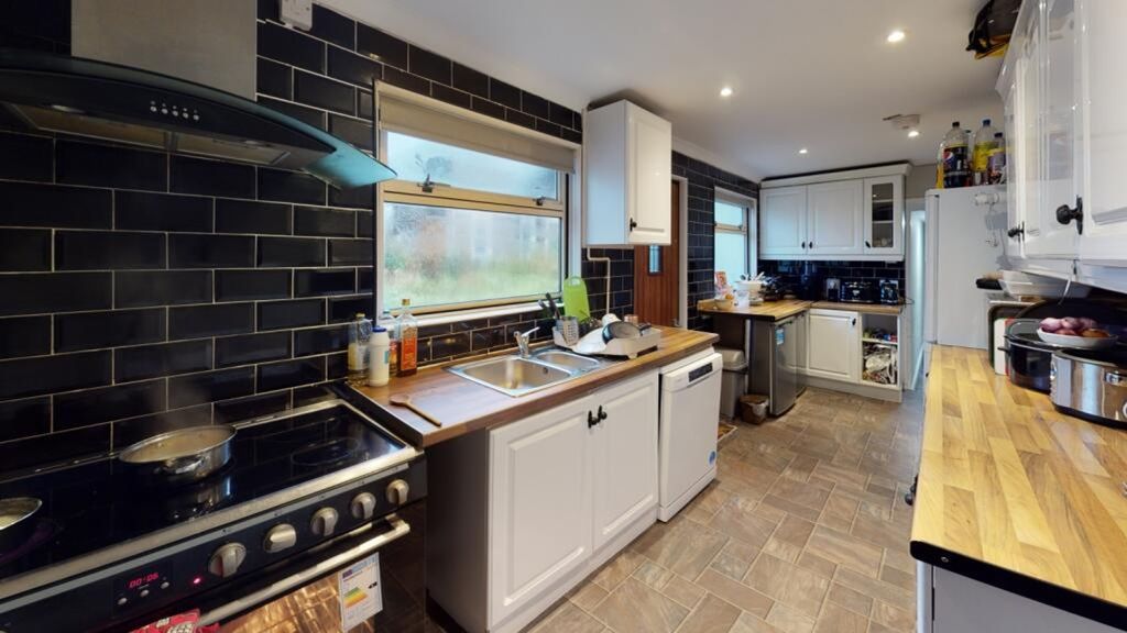 Property photo 3 of 7 This Modern Kitchen Features Sleek Cabinetry, Ampl...