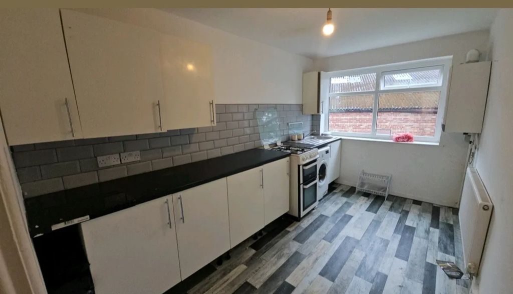 Property photo 1 of 8 This Modern Kitchen Features Sleek Cabinetry And A...