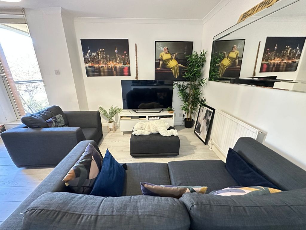 Property photo 2 of 10 A Bright And Modern Living Room Featuring Stylish ...